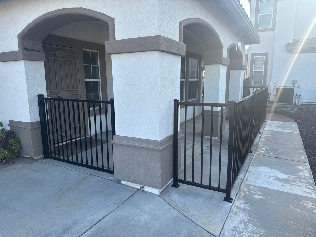 Black ornamental iron railing at residential home
